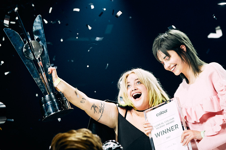 Woman celebrating on stage with award