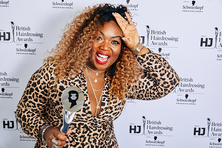 Woman celebrating backstage with award