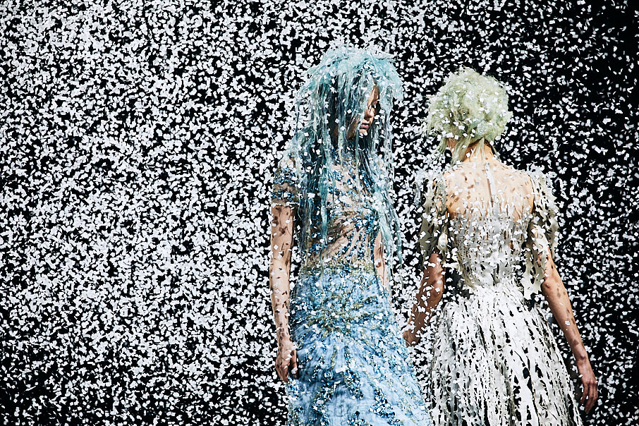 Toni & Guy female hair models dressed in metallic blue and silver on stage with dramatic hair and rain effect on stage
